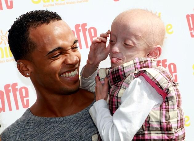 Aston Merrygold from JLS with Progeria suffer Ashanti Elliott-Smith aged nine from Burgess Hill at breakfast with children at the Giraffe restaurant in Marylebone, London.
Picture date: Thursday April 25, 2013. Aston and JB from band JLS joined Olympic m