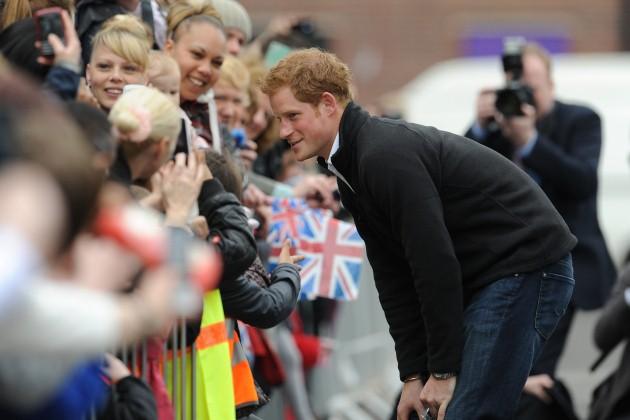 Prince Harry talks to children in the crowds outside after his visit to Russell Youth Club, Nottingham.
Picture date: Thursday April 25, 2013. 