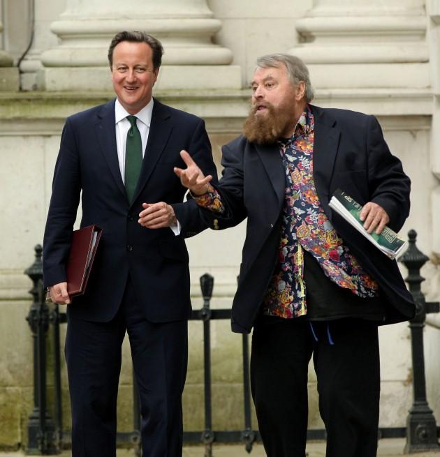 Prime Minister David Cameron (left)greeting Brian Blessed after returning from Parliament, at Downing Street, central London. Blessed is at Downing Street to hand in a giant postcard to the Prime Minister in support of greater transparency on animal resea