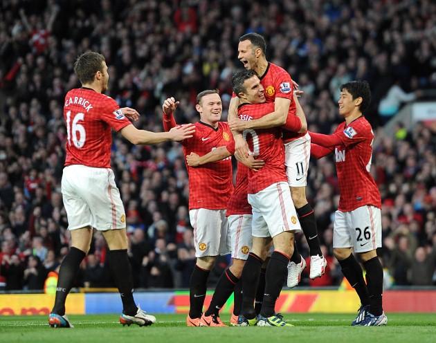Manchester United's Robin van Persie (centre) celebrates with his team-mate's after scoring his team's opening goal. Manchester United v Aston Villa at Old Trafford. April 22, 2013.