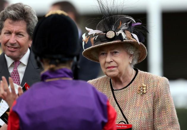 Queen Elizabeth II chats to jockey Hayley Turner before the Dreweatts 1759 Handicap during Dubai Duty Free Spring Trials Raceday at Newbury Racecourse, Berkshire.
Picture date: Friday April 19, 2013. 