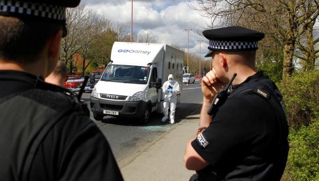 Police officers stands guard at the crime scene where two men escaped from a prison van that came under attack on Regent Road in Salford.
Picture date: Tuesday April 30, 2013