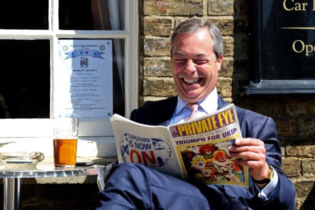 Leader of UKIP Nigel Farage, reacts as he looks at the latest edition of Private eye magazine during a visit to Ramsey in Cambridgeshire while on the local election campaign trail.
Picture date: Wednesday May 1st 2013.