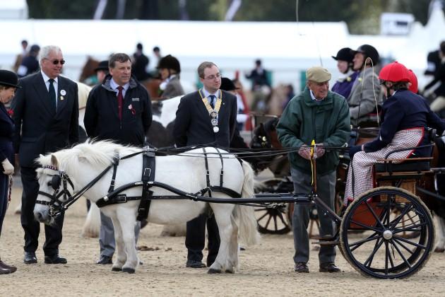 The Duke of Edinburgh watches and presents the trophies for the Driving for the Disabled class during the second day of the Royal Windsor Horse show, in Windsor.
Picture date: Thursday May 9, 2013.