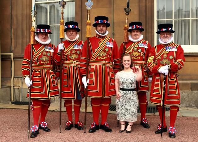 Paralympic swimmer Ellie Simmonds with members of the Yeoman of the Guards after she received her Officer of the British Empire (OBE) medal from the Prince of Wales during an Investiture ceremony at Buckingham Palace in central London.
Picture date: Frid