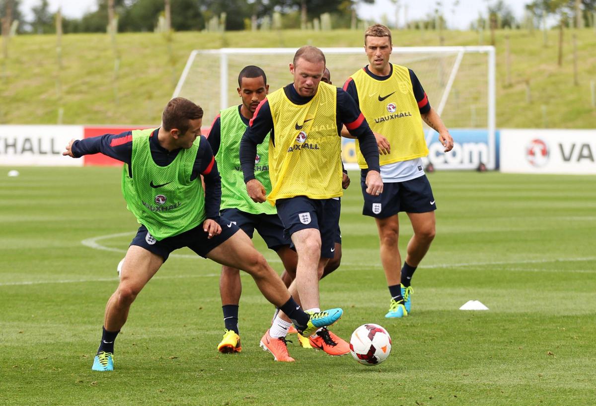 Rickie Lambert trains with the England squad, watching on as Wayne Rooney dominates possession
