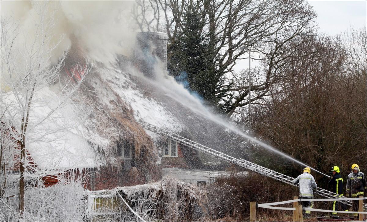 The Year in Pictures - 2013 - Firefighters got covered in foam whilst tackling a blaze at a thatched cottage in Dibden. March 29, 2013.
