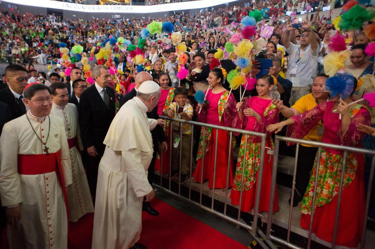 Pope
Francis
greets
people
as
he
arrives
for
a
meeting
with
families
at
the
Mall
of
Asia
arena
in
Manila,
Philippines. Picture of the Day for January 17, 2015.