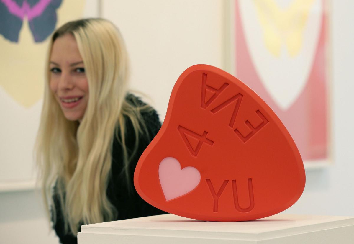 Art
student
Celia
Stolper
with
a
piece
during
the
private
view
of
LOVE,
a
pop-up
exhibition
of
prints
and
sculptural
editions
by
Damien
Hirst, Picture of the Day for February 10, 2015.