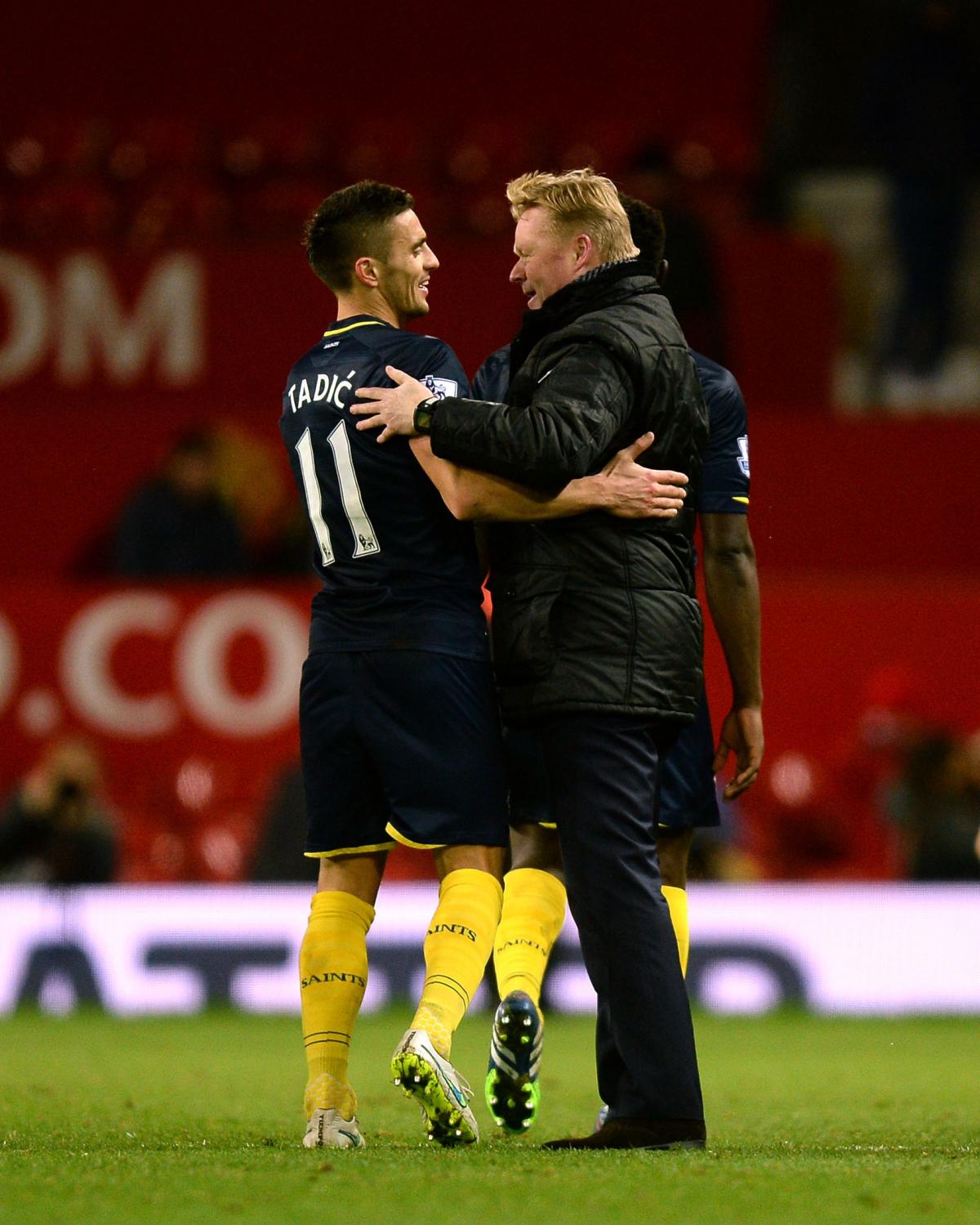 Koeman embraces Dusan Tadic after the midfielder gave them a 1-0 win at Manchester United, in January.