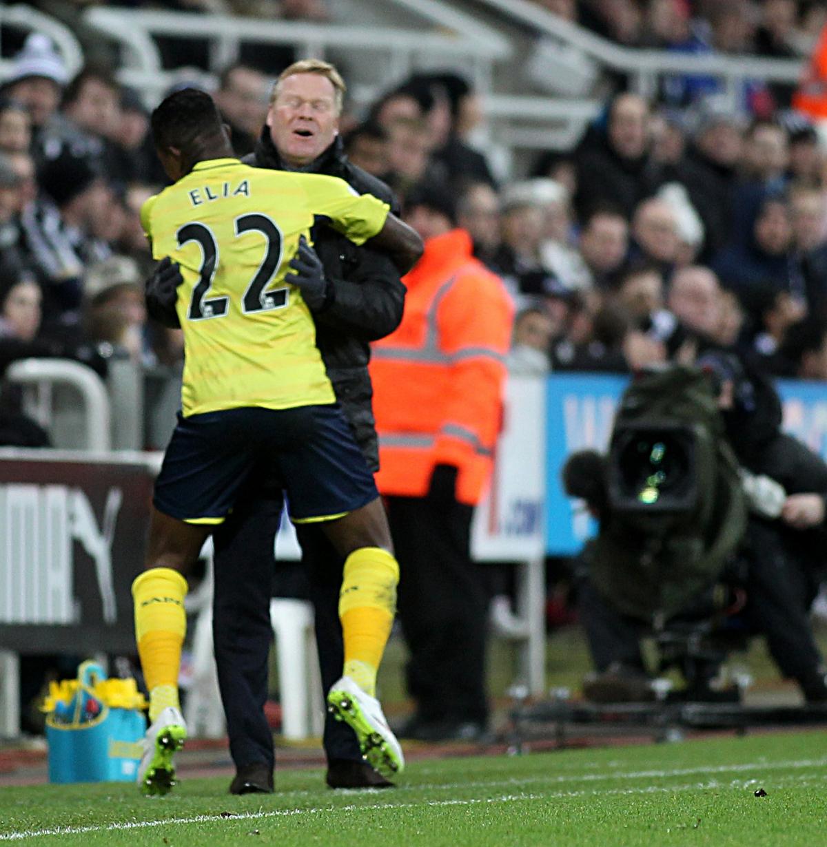 The wins keep coming, as Eljero Elia embraces Koeman after scoring in the 2-1 win at Newcastle.