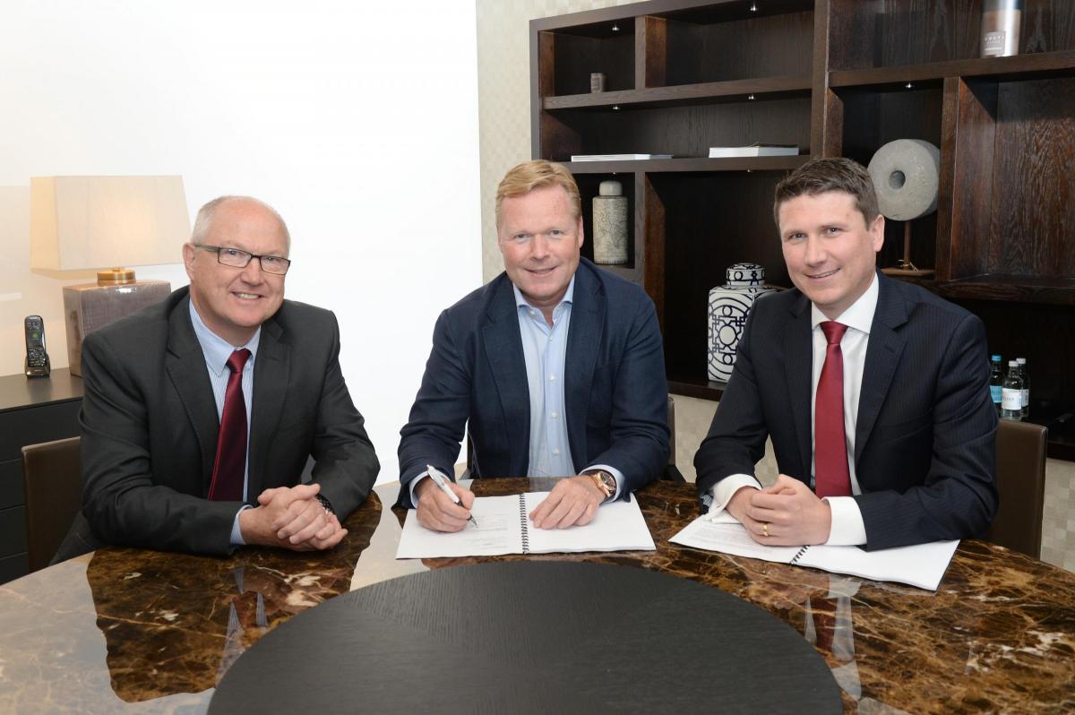 Ronald Koeman signs his Saints contract on June 16, 2014, alongside Les Reed (left) and Gareth Rogers (right). Photo: Robin Jones.