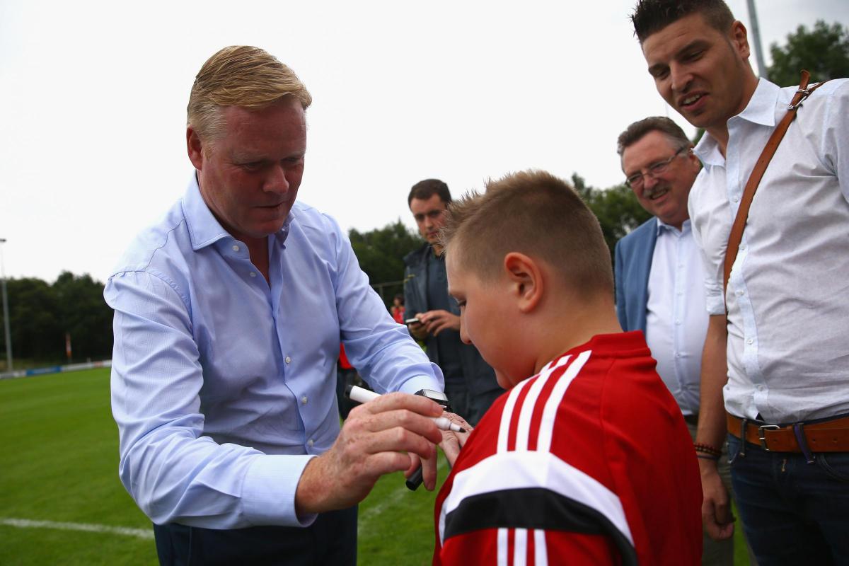 Ronald Koeman signs a young fan's shirt on the pre-season tour, ahead of the friendly against EHC Hoensbroek.