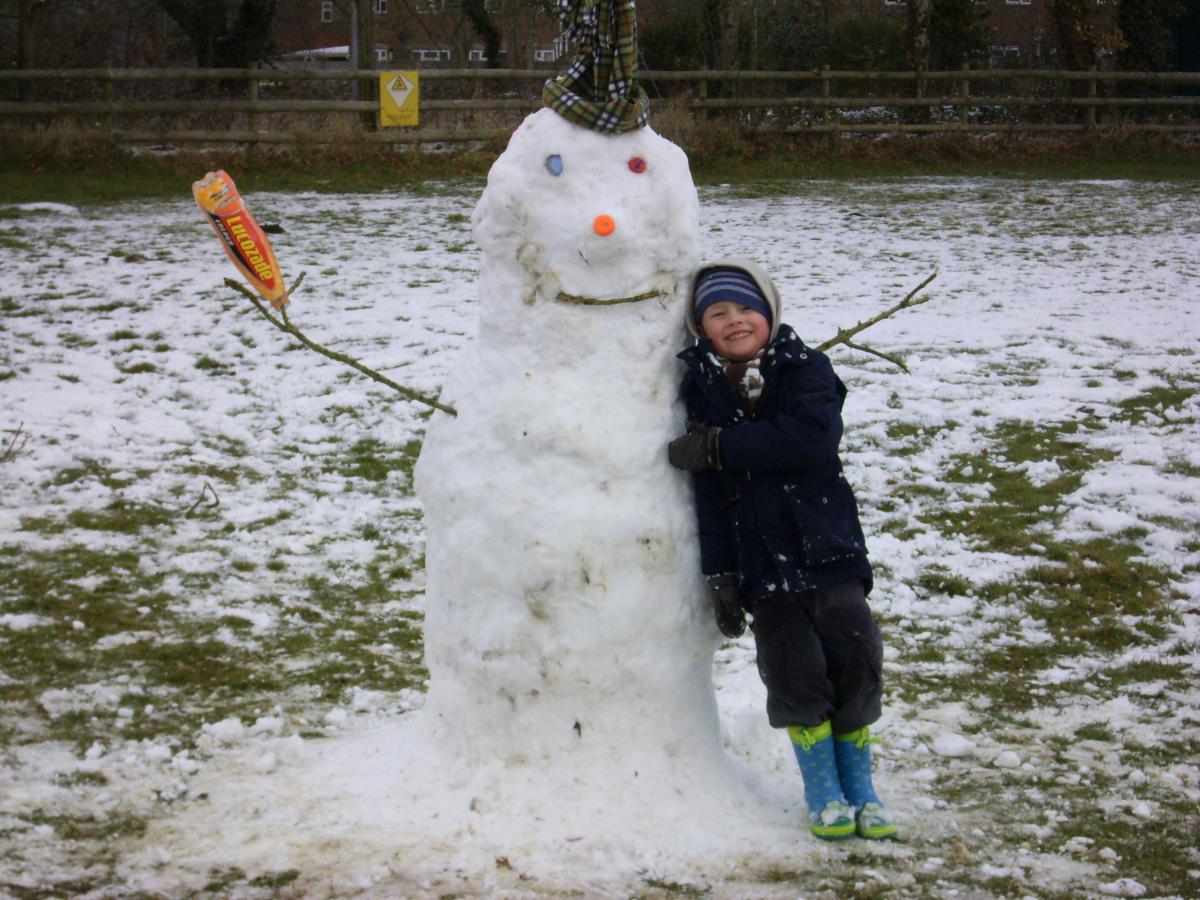 Snow covers Hampshire - Alfie Steadman with his snowman in West Moors