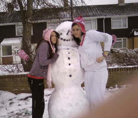 Snow covers Hampshire - Kassie and Jess with their snowman