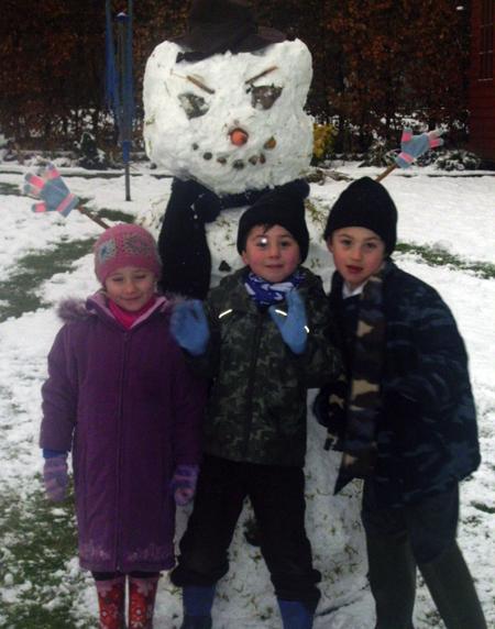 Snow covers Hampshire - Sophia Hayes with Tom and James Webber and their evil snowman