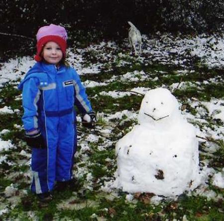 Snow covers Hampshire Noah Waterson and snowman at Whitely