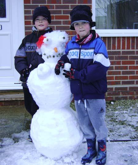 Snow covers Hampshire - Jamie and Louis with their Saints snowman