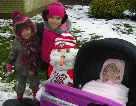 Snow covers Hampshire - Layla Yasmine and baby Evie with their snowman