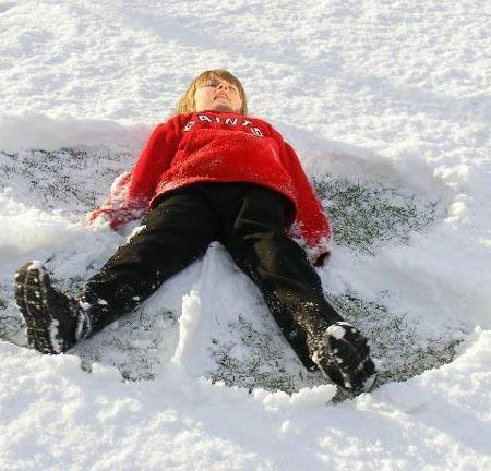 Snow covers Hampshire - Aidan makes a snow angel from Carol Sharp