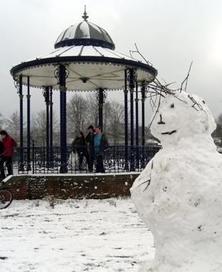 Snow covers Hampshire - Snowman by the bandstand by Andy Ross