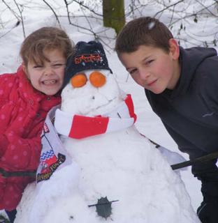 Snow covers Hampshire - Ethan and Paris with their Aldershot snowman