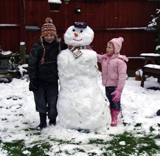 Snow covers Hampshire - Hayden and Rebecca Nailor with their snowman sent in by Michael Nailor