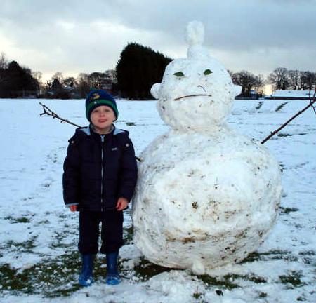 Snow covers Hampshire - Jack Williams at Bursledon with his snowman