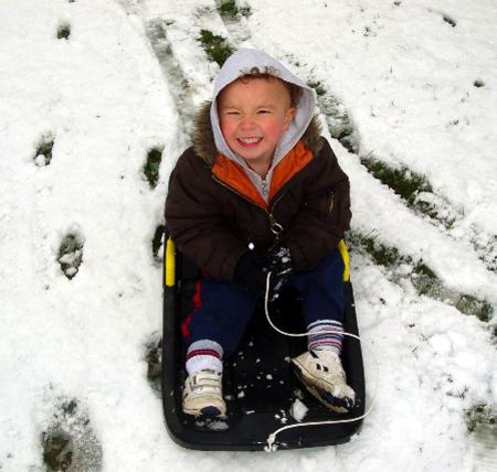 Snow covers Hampshire - Daniel Kimber on his sled taken by his mum, Linda