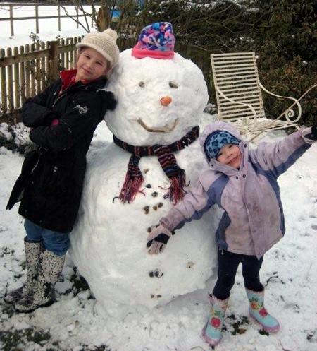 Snow covers Hampshire - Emily and Annabel Wall with their snowman 'Frosty'