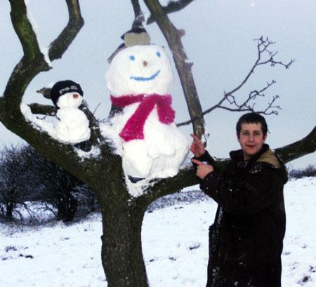 Snow covers Hampshire - Stephen with snowman up a tree
