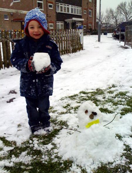 Snow covers Hampshire - Mackenzie Broadbridge aged 2 with his snowman