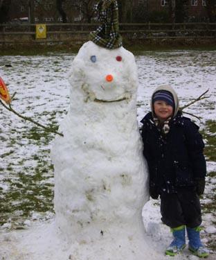 Snow covers Hampshire - Alfie Steadman with his snowman at Fryers Playing Field West Moors