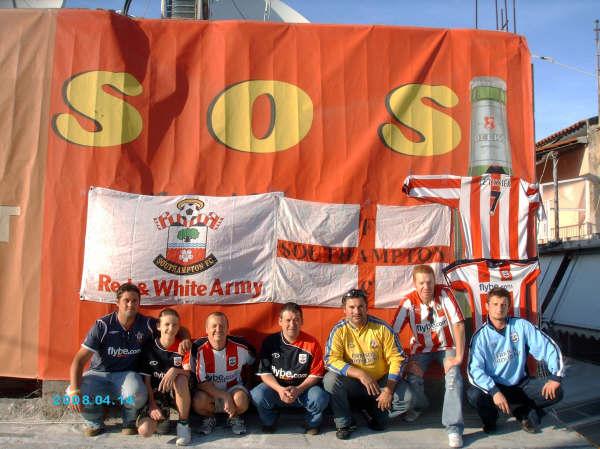 From left to right: Lee Marchant, Matt Waterman, Mick Waterman, Russ Brightman, Spiro, David Moores, Mario Zak, from the SOS Saints bar in Corfu