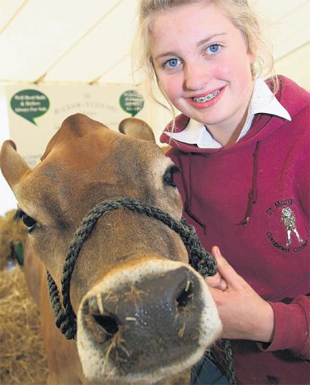 MAKING FRIENDS: Emily Vallis with a Jersey cow.