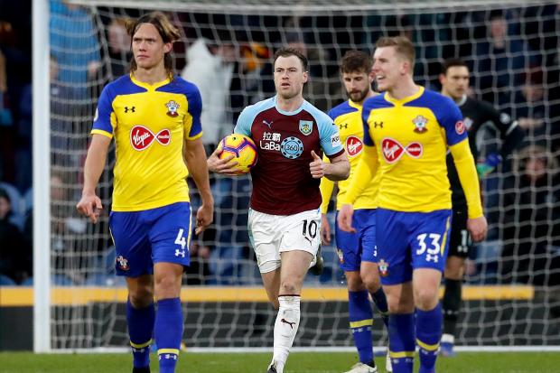 Burnley's Ashley Barnes (centre) collects the ball after scoring his side's first goal of the game from the penalty spot during the Premier League match at Turf Moor, Burnley.