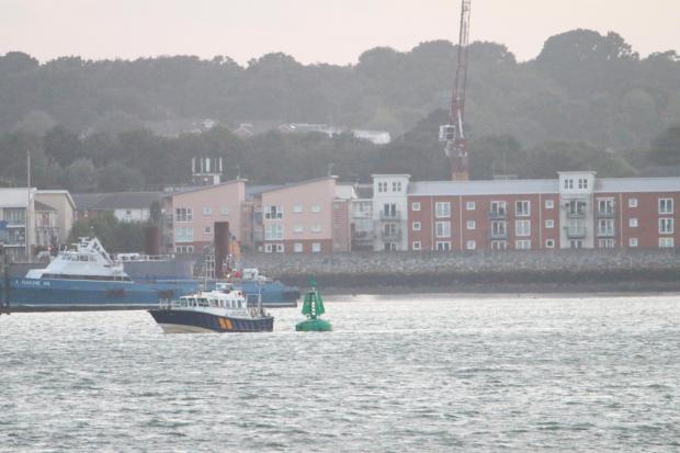 Daily Echo: The Harbour Master launch investigates a buoy near Hythe in Southampton Water. Picture: PA