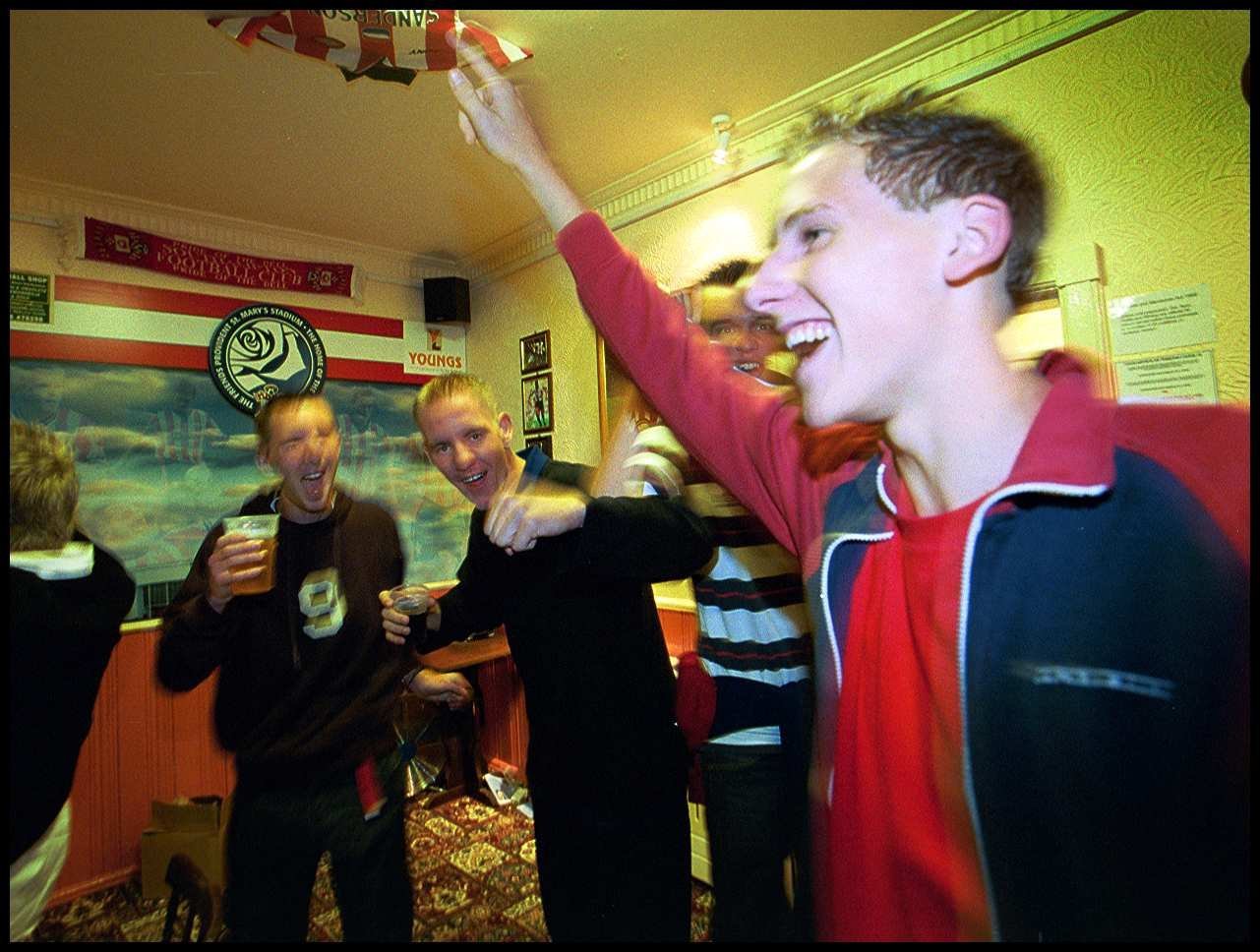 England fans celebrate Beckhams equaliser v Macedonia at the Le Tissier Legs pub.