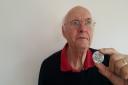 Ian Thomson with the 1936 German medallion found in his parents' garden in 1961.