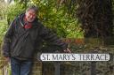 Oliver Gray with the sign at St Mary's Terrace in Twyford