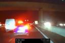 A car swerves in front of an unmarked police vehicle as it overtakes a van on the M27