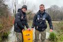 Lyndon Fennell (left) and William West restocking Millers Pond in Sholing with fish