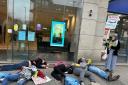 Climate and pro-Palestine campaigners staged a protest pretending to be dead outside Barclays on Above Bar Street