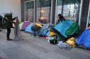 Activists helped migrants pack their belongings after they were woken before dawn by officers (Nicolas Garriga/AP)