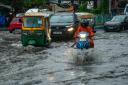 Vehicles move through a waterlogged street in Kolkata, India (AP Photo/Bikas Das)