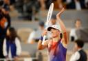 Iga Swiatek celebrates after winning her first-round match (Jean-Francois Badias/AP)