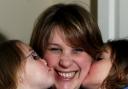 KISS OF LIFE: Lorraine Robinson, pictured with her daughters Naomi and Abigail, who were vaccinated against swine flu following a campaign in the Daily Echo. Echo picture by Matt Watson. Order no: 10167455