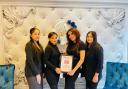 The team at Ange's Brow & Waxing, with Amarjeet holding the winner's certificate
