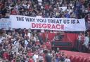 Manchester United fans display a banner in protest in the stands (Peter Byrne/PA)
