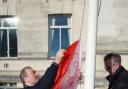 Mike King raises the Socialist Party flag at the Civic Centre.